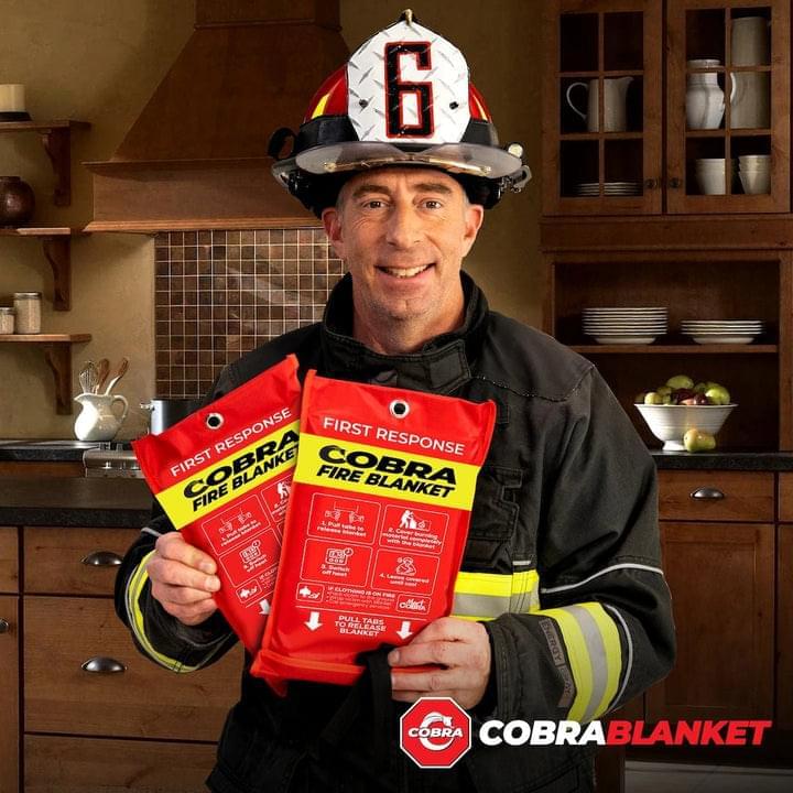 Firefighter holding Cobra Fire Blanket